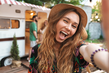 Poster - Cheerful young girl taking a selfie