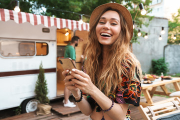 Sticker - Cheerful young girl using mobile phone