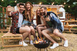 © Drobot Dean - Group of cheerful happy friends sitting at the trailer