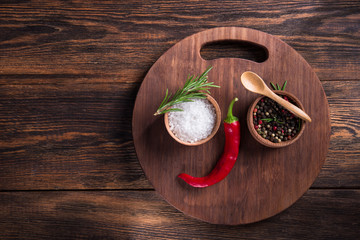 Wall Mural - Salt, black seed pepper, branch of rosemary, red hot chili