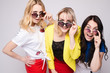 © Вячеслав Косько - Stock portrait of three women in fashionable sunglasses looking at camera with different facial expressions. Women looking at camera over their sunglasses with excitement and suspense.