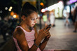 © cherryandbees - young girl using mobile phone outdoor. night scene