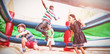 Friends jumping on bouncy castle