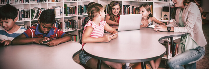 Teacher using technology with pupils
