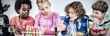 Kids Doing A Chemical Experiment In Laboratory