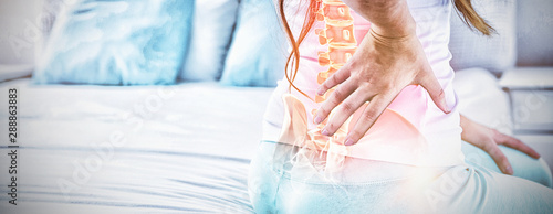 Fotografía Digital composite of highlighted spine of woman with back pain