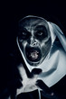 frightening evil nun with bloody teeth