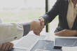 © Puwasit Inyavileart - Shake hands of businessmen, young men, the company's financial accountants join hands to congratulate the owners of successful companies that are very profitable, financial business
