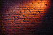 Old retro red brick wall being lit by a stage light bulb light. Constant light modifier projecting light on it