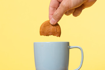 Dunking a biscuit in a mug of tea.