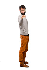 Wall Mural - Handsome man points finger at you with a confident expression over isolated white background