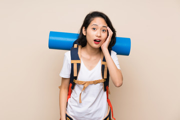 Asian traveler woman over isolated background with surprise and shocked facial expression