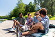 © Syda Productions - leisure, picnic and people concept - friends hanging out and talking outdoors in summer park
