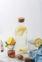 Wall Mural - Ginger Water and its Ingredients, Such as Lemon and Honey, Vertical Orientation