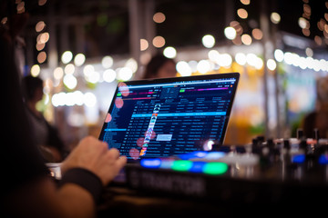 Dj Plays at Event. Traktor on the Desktop Computer.