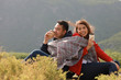 © chayathon2000 - Asian couple drinking coffee travel in winter time mountain view background