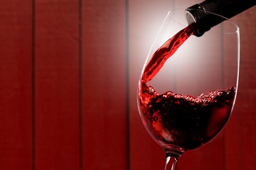 Poster - Red wine being poured in wineglass, closeup