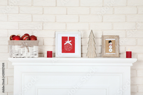 White Fireplace With Christmas Ornaments Photo Frames And Wooden