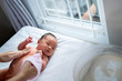 © Odua Images - newborn baby bath using wet towel with mother at home