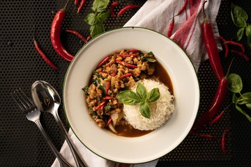 Poster - Overhead shot of a dish with rice and red peppers in a white round plate