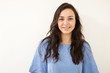 © Hazal - Portrait of young beautiful girl smiling looking at camera over white background.