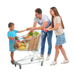 Wall Mural - Happy family with full shopping cart on white background