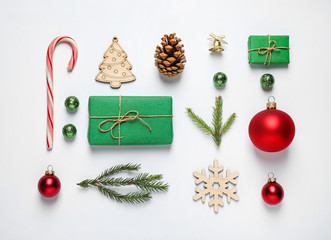 Christmas tree branches and festive decoration on white background, top view