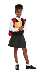 Happy African-American girl in school uniform on white background