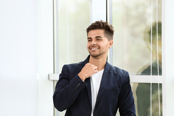 Poster - Portrait of handsome young man near window