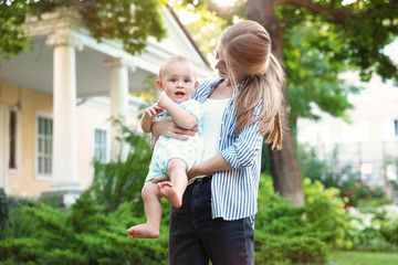 Sticker - Teen nanny with cute baby outdoors on sunny day