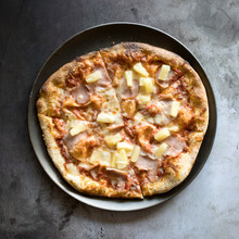 Hawaiian Pizza On A Concrete Background
