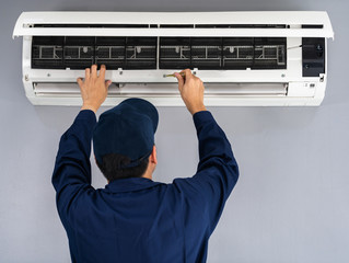 Wall Mural - Technician service using screwdriver to repairing air conditioner