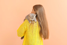 Beautiful Young Woman With Cute Cat On Color Background