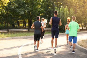 Poster - Group of sporty young people running outdoors