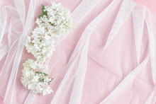 White Tulle And Beautiful Hydrangea Flowers. Pink Table Background. Feminine Wedding, Birthday Floral Concept. Flat Lay, Copy Space.