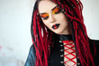 Beautiful young woman with piercing, dreads and stylish make-up.  Woman cyberpunk.