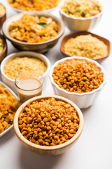 Wall Mural - Group of Cornflake and Thick Poha Chivda or Chiwda and Chatpata Masala chana and fried crispy Moong Dal, served in a bowl. selective focus