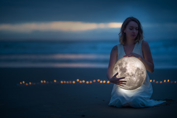 Wall Mural - gentle image of a girl, astrology, female magic. beautiful attractive girl on a night beach with san