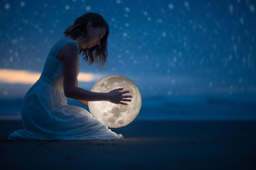 Wall Mural - tender image of a girl; female magic. beautiful attractive girl on a night beach with sand and stars
