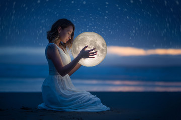 Wall Mural - delicate photography, astrology, women's magic. beautiful attractive girl on a night beach with sand