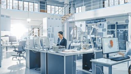 Aufkleber - Female Chef Engineer Working on Computer, Programming Robot Arm in Bright Modern Industrial Robotics Technology and Design Office. Working in Research Facility.