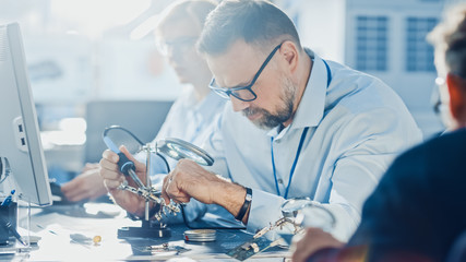 Poster - Team of Electronics Development Engineers Working on Computers, Designing Motherboard, Doing Maintenance of Devices and Soldering Circuit Boards. Professionals working in Bright and Modern Office 