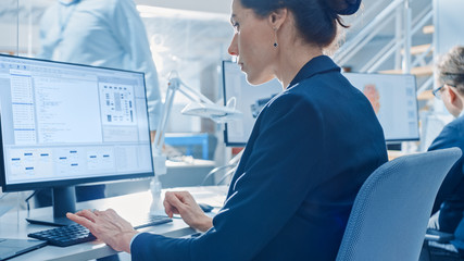 Poster - Back View of Team of Technology Engineers Working on Desktop Computers in Bright Office. Screens Show IDE / CAD Software, Implementation of Machine Learning, Neural Networking and Cloud Computing