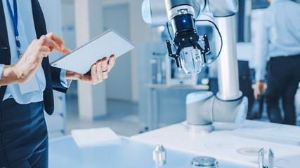 Aufkleber - Stylish Female Industrial Robotics Engineer Uses Tablet Computer to Program and Manipulate Robot Arm for Lifting, Moving Objects. Technology Research Facility for Machine Learning and Cloud Computing