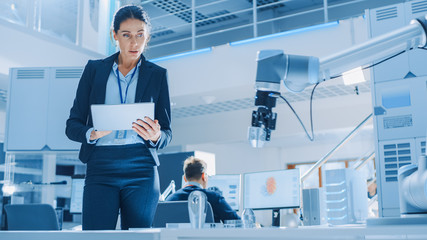 Aufkleber - Stylish Female Industrial Robotics Engineer Uses Tablet Computer to Program and Manipulate Robot Arm for Lifting, Moving Objects. Technology Research Facility for Machine Learning and Cloud Computing