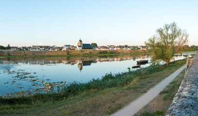 Sticker - picturesque smalltown of Jargeau in the French countryside on the Loire river with riverboats in the foreground