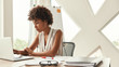 © Friends Stock - Business expert. Beautiful afro american woman working with laptop while sitting in the modern office