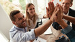 © Friends Stock - Successful team Business people giving each other high-five and smiling while working together in the modern office