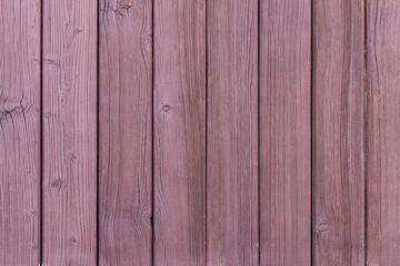 Wall Mural - A wooden wall made of vertical old ragged painted reddish planks. Texture abstract background