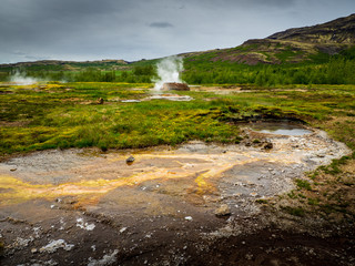 Geysers and steam in Icelandic landscape